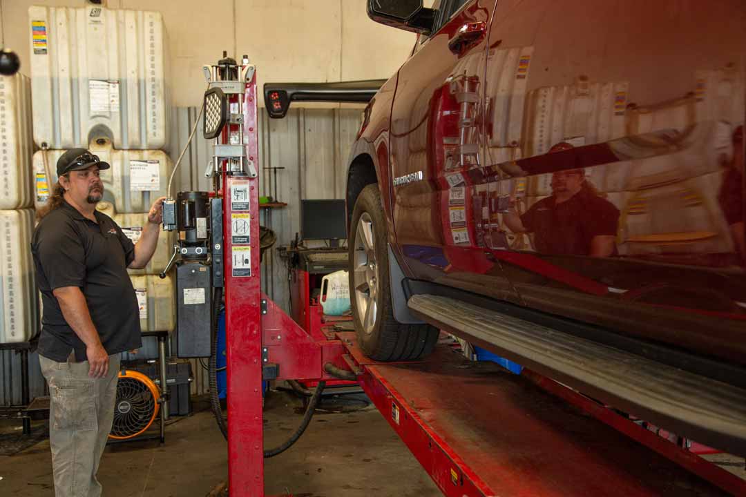 Auto Mechanic working on a vehicle at Alpha Auto Center in Dallas, GA